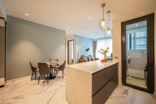 a kitchen and dining room with a dining table at Metropole Thu Thiem Condo Apartment in Ho Chi Minh City