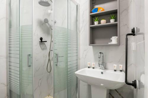 a bathroom with a glass shower and a sink at Sea of Galilee Panorama Apartment by Sea N' Rent in Tiberias