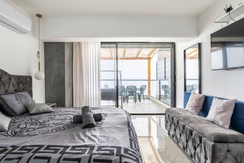 a bedroom with a large bed and a couch at Sea of Galilee Panorama Apartment by Sea N' Rent in Tiberias