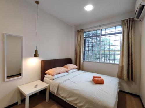 a small bedroom with a bed and a window at Eden 8pax 3Rooms apartment near Kuching Airport in Kuching