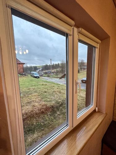 a window with a view of a field at Карпатська ніч in Plav'ya