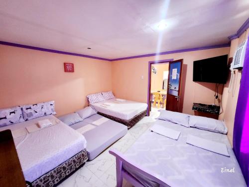 A bed or beds in a room at Einel Homestay 1