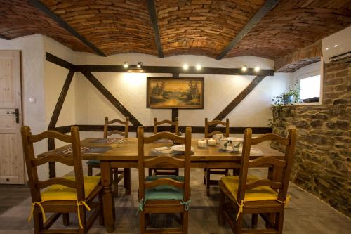 a dining room with a wooden table and chairs at Apartament Agroturystyka Koniec Świata in Lesna