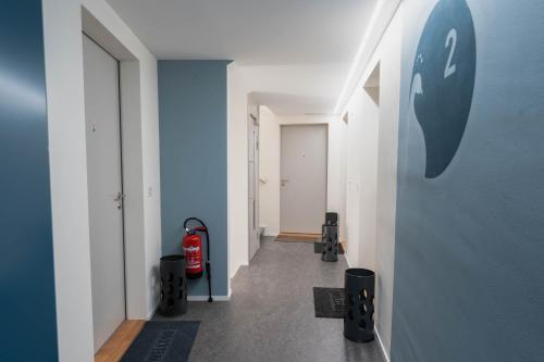 a hallway with a wall with an apple logo on it at INN JOY Apartments - Sankt Gallen Center in St. Gallen