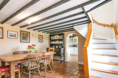 a kitchen and dining room with a wooden table and chairs at Sweet Lamb Farmhouse in New Ross