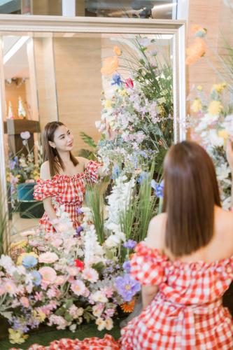 a woman looking at herself in a mirror at P2 Boutique in Bangkok