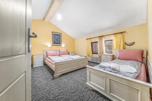 a bedroom with two beds and a window at House Shiligarnika in Bansko