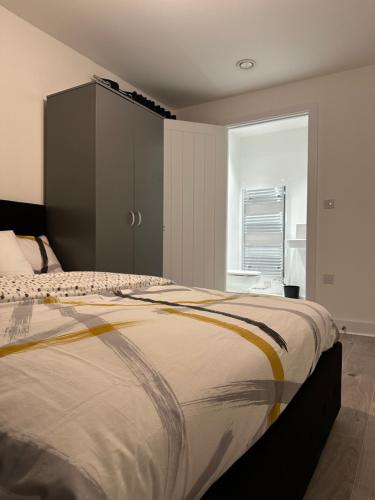 a bedroom with a large bed and a large window at Lush Place in Manchester