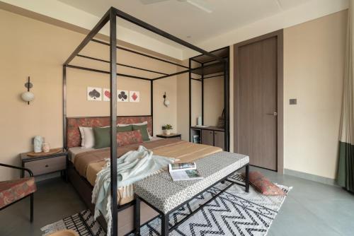 a bedroom with a canopy bed and a table at The Deck in Jaipur