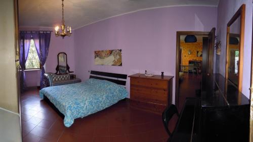 a bedroom with a bed and a dresser and a mirror at Casa Elena in Lerici