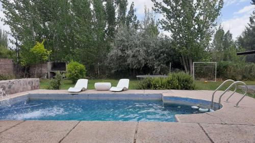 a small pool with two chairs and a soccer ball at Paz y Vino in Ciudad Lujan de Cuyo