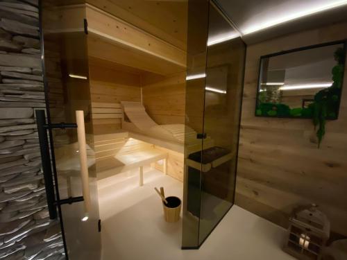 a room with a sauna with a glass wall at Apartmány & Wellness Revenite in Jeseník