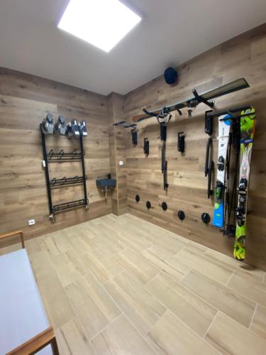 un gimnasio con pared de madera y equipamiento de gimnasia póquer en Apartmány & Wellness Revenite, en Jeseník