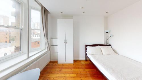 a white bedroom with a bed and a window at Flat 302 Centre Nottingham in Nottingham