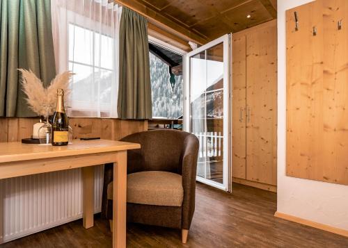 een kamer met een bureau, een stoel en een raam bij AURA Bed & Breakfast in Sankt Jakob in Defereggen