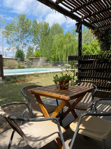 una mesa de madera y sillas en un patio en San Julián en San Rafael