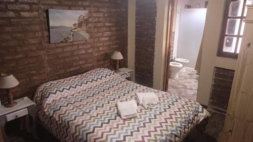 a hotel room with a bed and a bathroom with a bathroom at Cabañas de los Andes in Uspallata