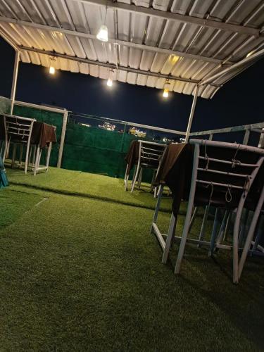 a group of chairs under a tent in a field at The Royal Lake View Villa in Udaipur
