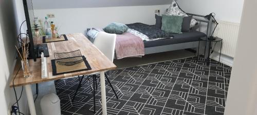 a room with a bed and a table with a table at Pension Kalbach by Marion in Mittelkalbach