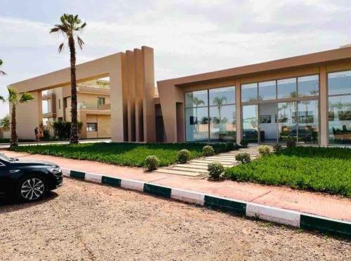 a car parked in front of a building at Villa California vue Atlas avec piscine chauffée in Marrakesh