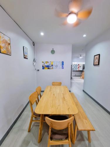 a wooden table and chairs in a room at Airport Neko House in Hat Yai