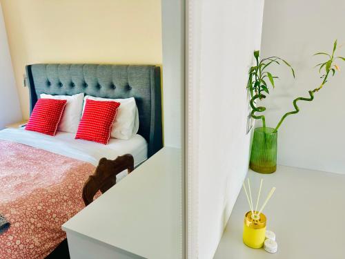 a bedroom with a bed with red pillows and a mirror at ROYAL RED SUITE NO 1, PIRAEUS PORT in Piraeus