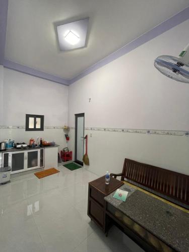 a living room with a couch and a table at Homestay Hoàng Phúc in Cu Lao Thu