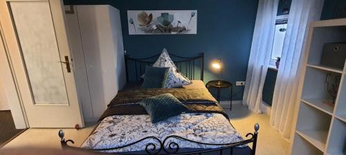 a bedroom with a bed in a room with blue walls at Pension Kalbach by Marion in Mittelkalbach