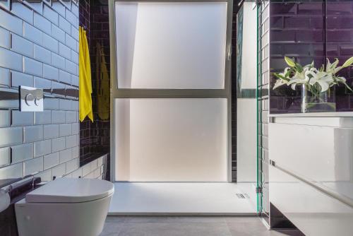 a bathroom with a toilet and a sliding door at Marbell in Gandía