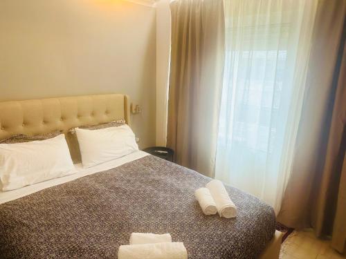 a bedroom with a bed with two towels on it at Royal Red suite No2 PIRAEUS PORT in Piraeus