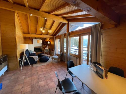 ein Wohnzimmer mit einem Tisch und Stühlen in der Unterkunft Appartement 5 ch. Ski-in/out in Verbier