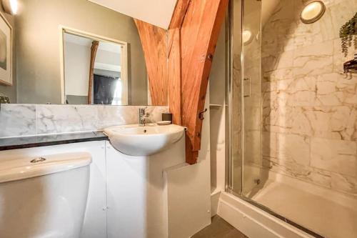 a bathroom with a sink and a toilet and a shower at Lofty Apartment in Plymouth in Plymouth