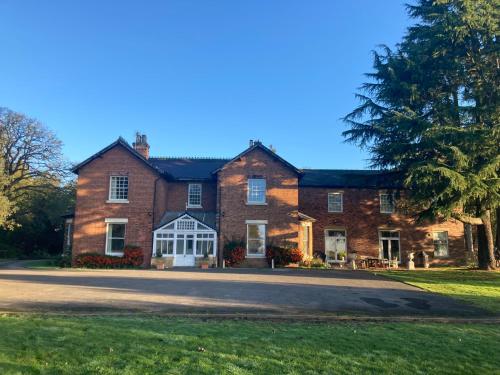 a large red brick house with a driveway at North Clifton Hall in North Clifton