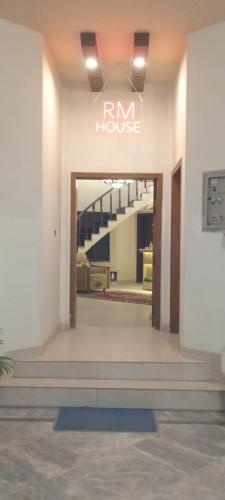 a entrance to a building with a sign that reads im house at R.M RESIDENCY in Lahore