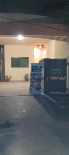 a sign in front of a building with a bm check house at R.M RESIDENCY in Lahore