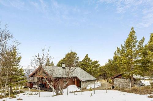 a log cabin in the snow with trees at Koslig hytte ved Grimsdalen in Dovre