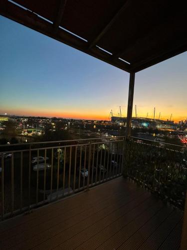 a balcony with a view of a city at night at Apt - Stay 6 - Stadium View - Coo-op Live Arena in Manchester