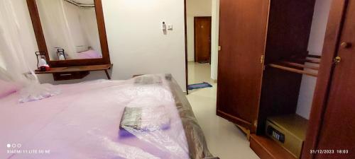 a bed is wrapped in plastic in a room at Villa Tanzanite Hikkaduwa in Hikkaduwa