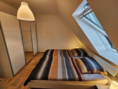 a bedroom with a bed in the attic at 3 Zimmerwohnung am Neuer Teich in Wolfsburg