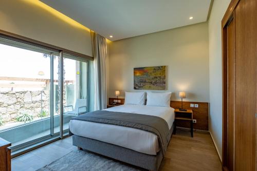 a bedroom with a bed and a large window at Dakhla South Bay in Dakhla