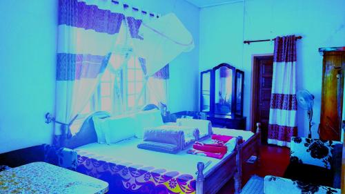 a room with a bed with two bags on it at Bel View Guest House in Haputale