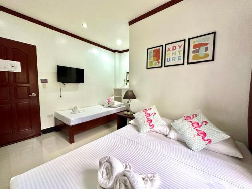 a bedroom with a bed and a bathroom with a sink at Endless Summer Hotel Baler in Baler