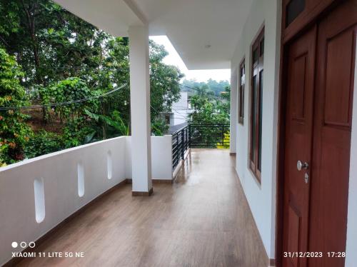 a hallway of a house with a balcony at Villa Tanzanite Hikkaduwa in Hikkaduwa