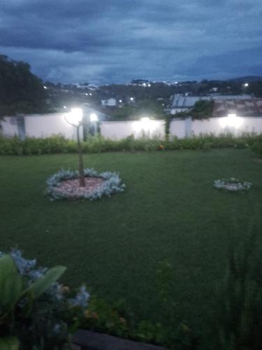 a yard with a light in the grass at night w obiekcie La tendresse w Antananarywie