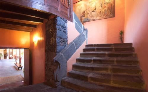 a staircase in a house with a stone wall at Hotel LIVVO La Quinta Roja in Garachico