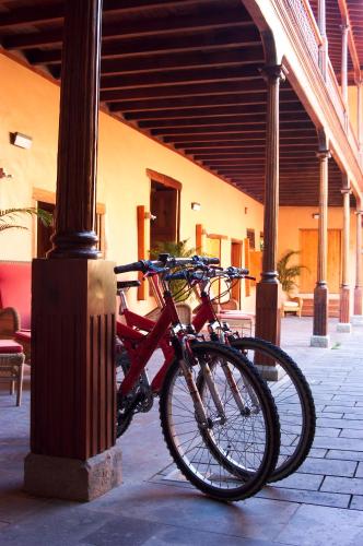 a bike is parked next to a pole at Hotel LIVVO La Quinta Roja in Garachico