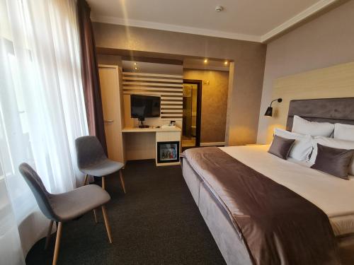 Ένα ή περισσότερα κρεβάτια σε δωμάτιο στο Boutique Hotel Cattaleya