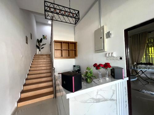 a room with a staircase and a stair case at Qiu's Event House Std Double Room in Kuala Berang