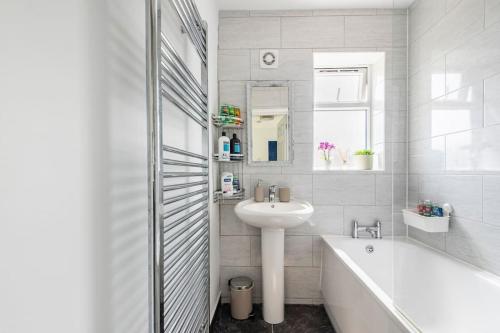 a white bathroom with a tub and a sink and a bath tub at Space House in Sheffield