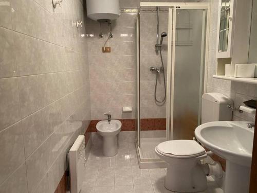 a bathroom with a shower and a toilet and a sink at [App. Tremol] 50 mt da piste sci in Piancavallo